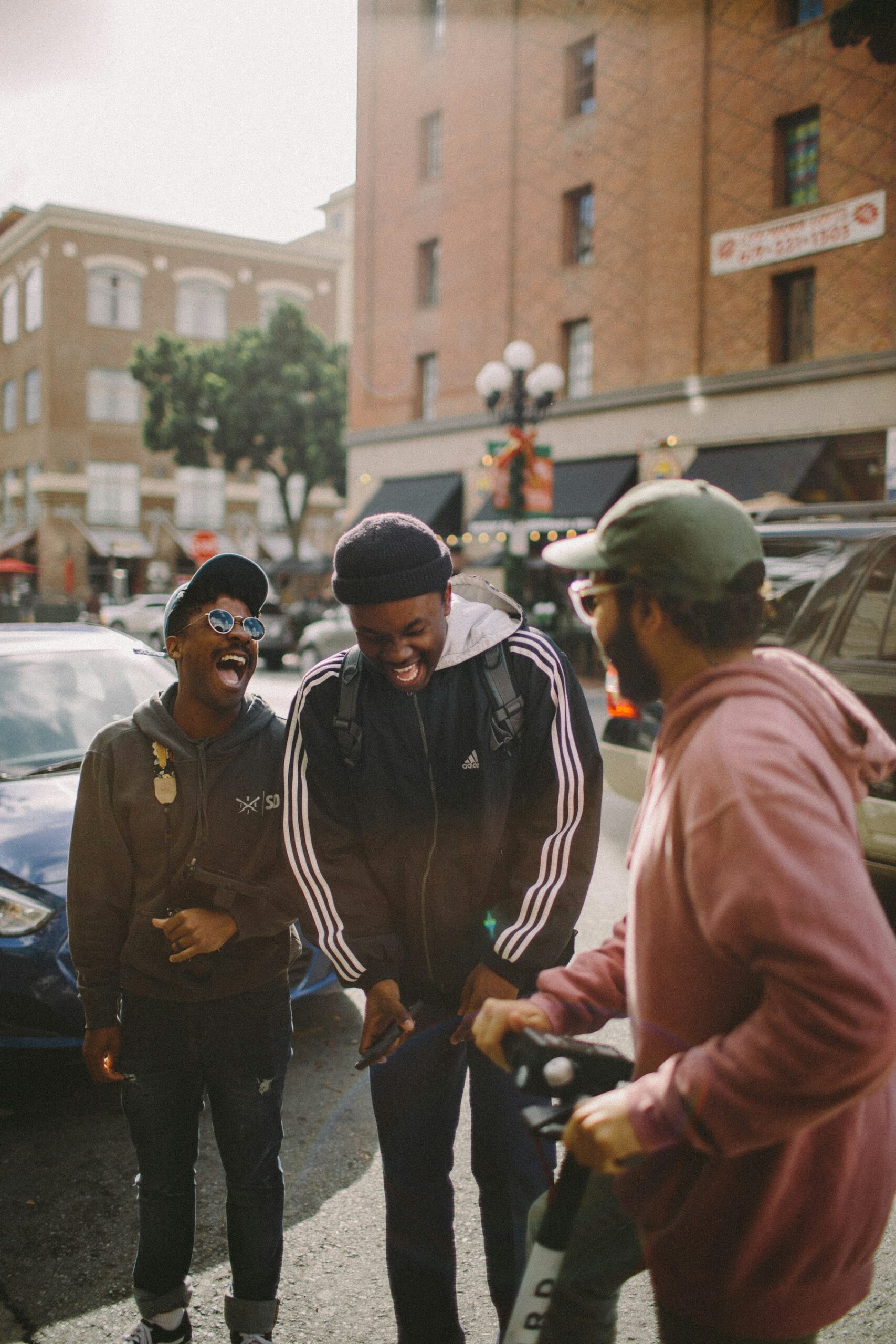 Three mates laughing together on the street